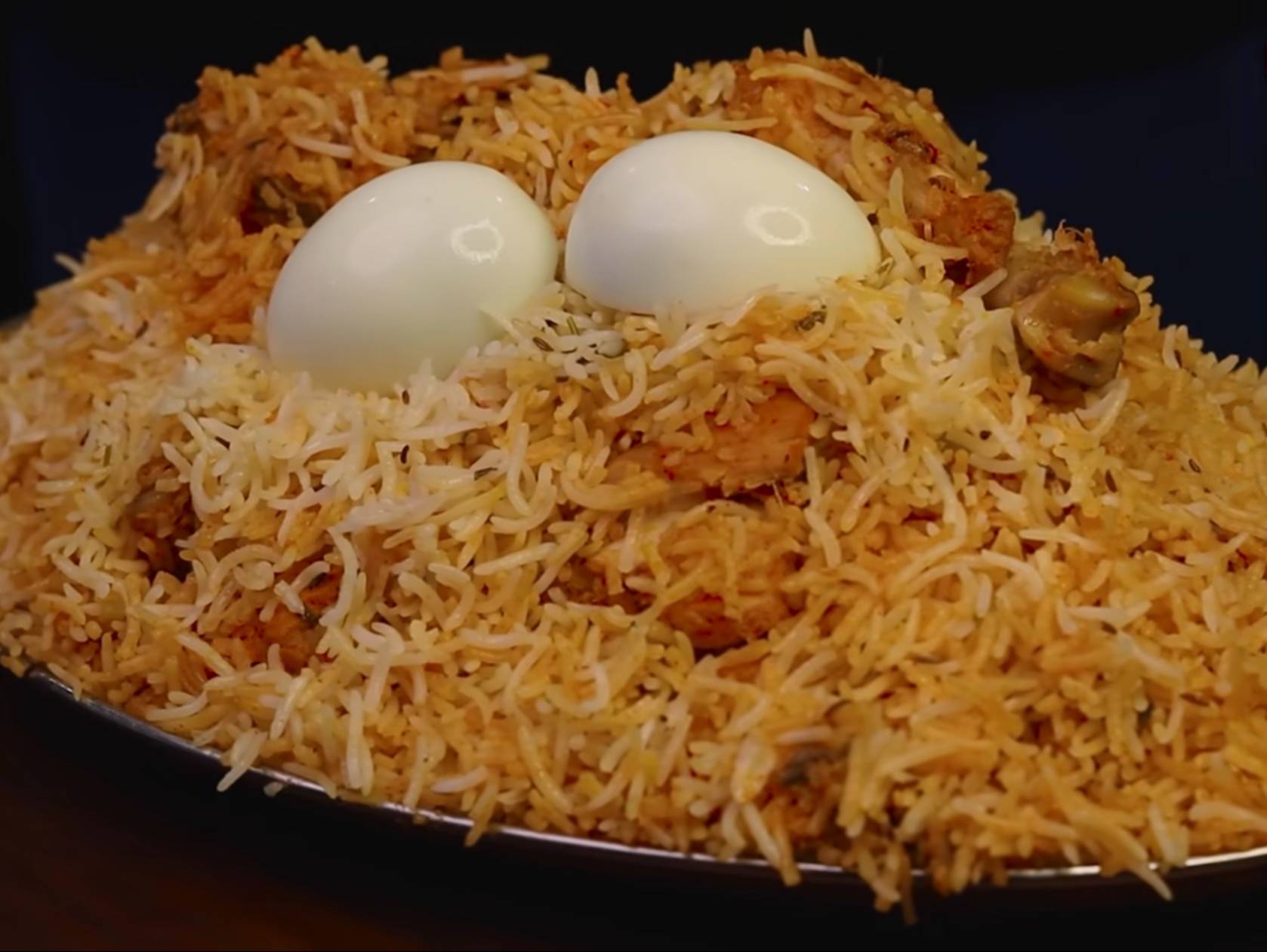 Hyderabadi chicken dum biryani—basmati layered with marinated chicken, saffron and fried onions